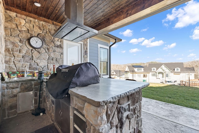 view of patio with an outdoor kitchen and a grill