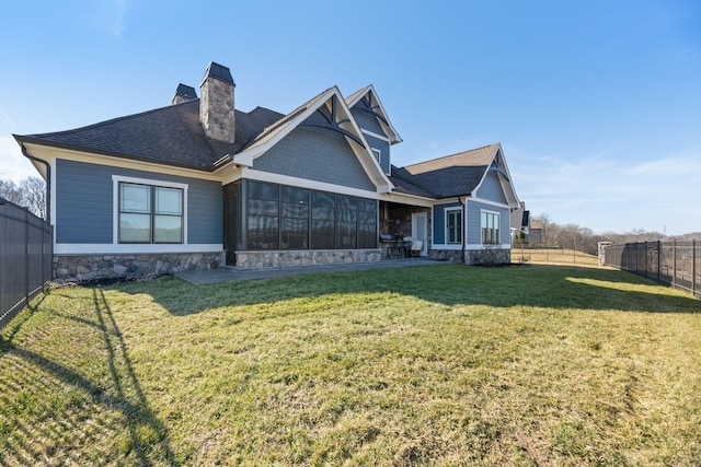 back of house featuring a lawn
