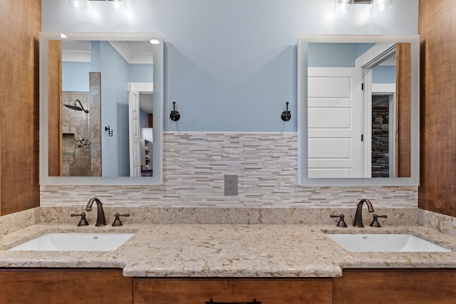 bathroom with vanity, crown molding, decorative backsplash, and walk in shower