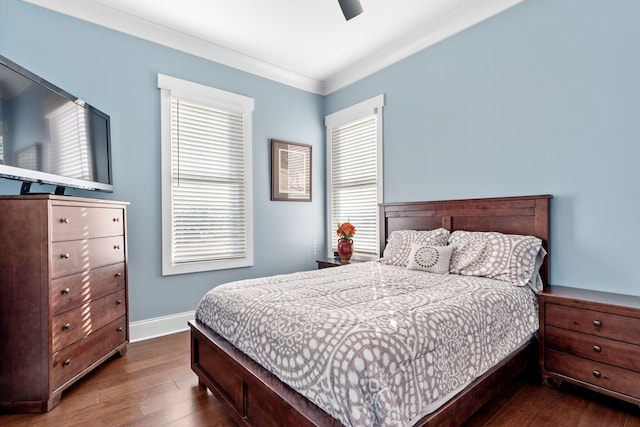 bedroom with dark wood-type flooring, ceiling fan, and ornamental molding