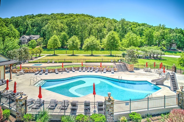 view of swimming pool featuring a yard and a patio
