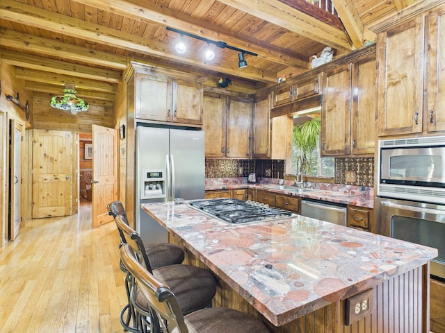 1150 Pin Hook Rd, Spring City, TN 37381 - kitchen with appliances with stainless steel finishes, a wooden ceiling with exposed beams, light wood-style floors, backsplash, and brown cabinetry