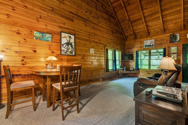 interior space with beamed ceiling, high vaulted ceiling, wood walls, and wood ceiling