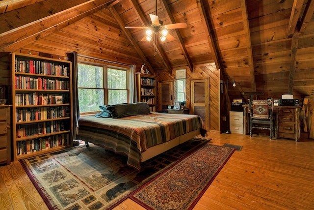 bedroom with wooden walls, wooden ceiling, vaulted ceiling with beams, and hardwood / wood-style floors