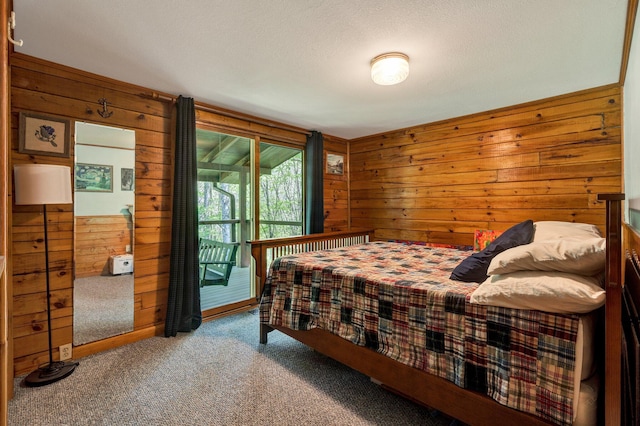 carpeted bedroom with wooden walls and access to exterior