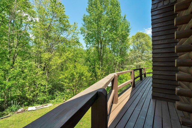 wooden deck with a wooded view