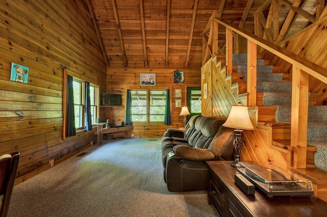 carpeted living area featuring wooden walls, high vaulted ceiling, wooden ceiling, visible vents, and stairway