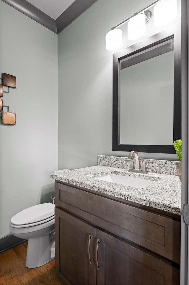 1422 Adams St, Chattanooga, TN 37408 - half bathroom with toilet, vanity, and wood finished floors