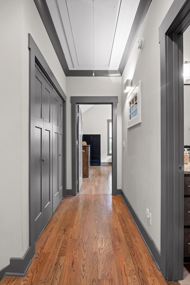 1422 Adams St, Chattanooga, TN 37408 - hallway featuring attic access, light wood-type flooring, and baseboards