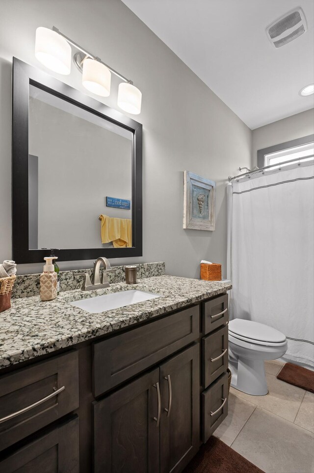 1422 Adams St, Chattanooga, TN 37408 - full bath with vanity, toilet, tile patterned floors, and a shower with curtain