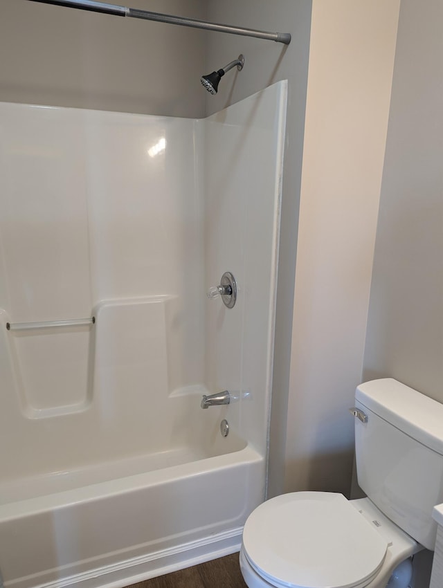 bathroom featuring shower / bathing tub combination and toilet