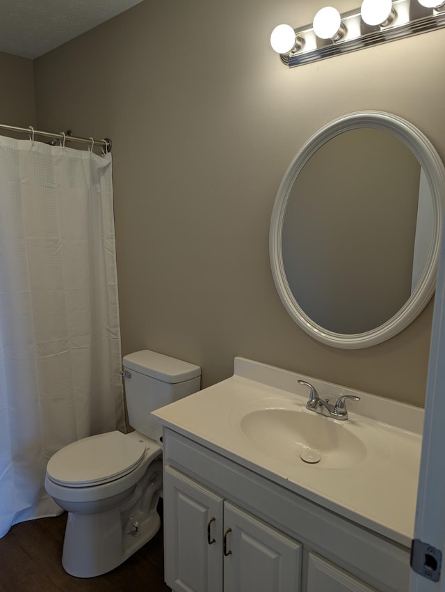 bathroom with vanity, wood-type flooring, toilet, and walk in shower