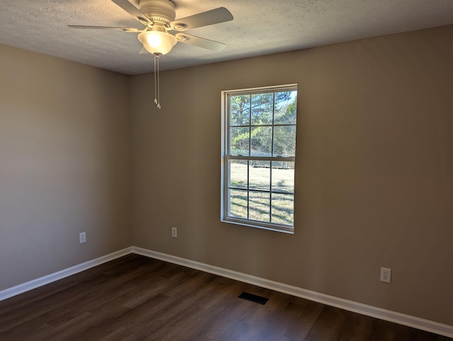 spare room with ceiling fan, dark hardwood / wood-style floors, and a textured ceiling