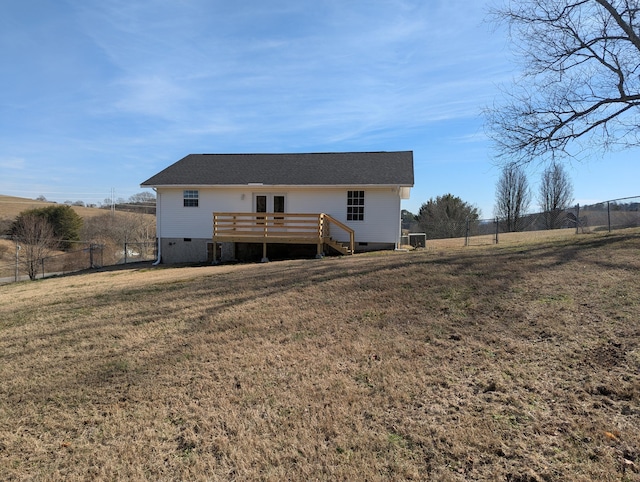 back of house featuring a yard, a rural view, and a deck