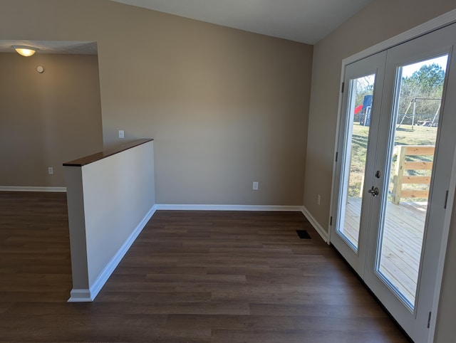 spare room with french doors and dark hardwood / wood-style floors