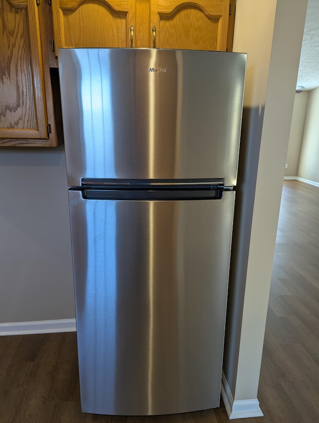 room details featuring stainless steel refrigerator and dark hardwood / wood-style floors