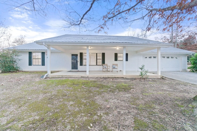 view of front of property featuring a garage and covered porch