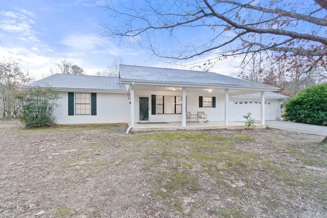 ranch-style house with a garage and covered porch