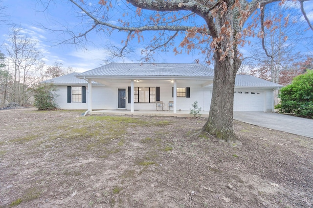 single story home with a porch and a garage