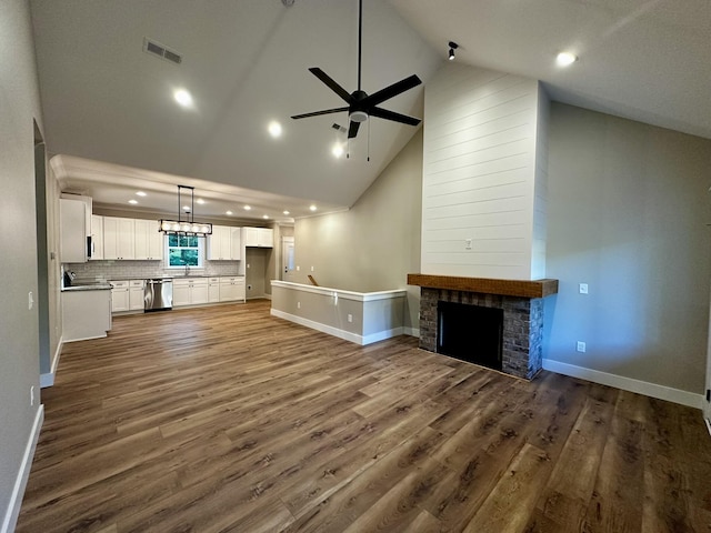 110 Dakota Dr NE, Cleveland, TN 37323 - unfurnished living room featuring ceiling fan, recessed lighting, high vaulted ceiling, wood finished floors, and a fireplace