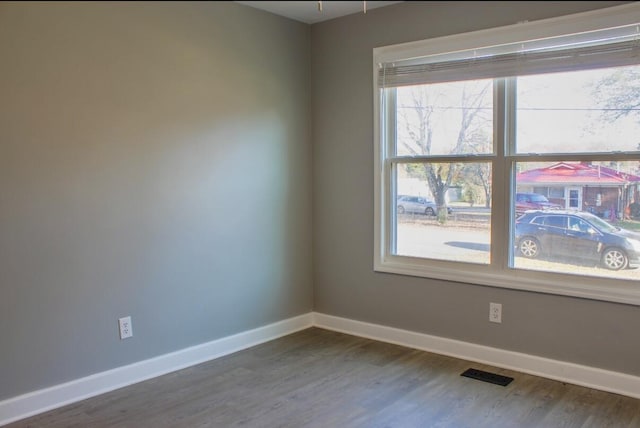 spare room with hardwood / wood-style floors