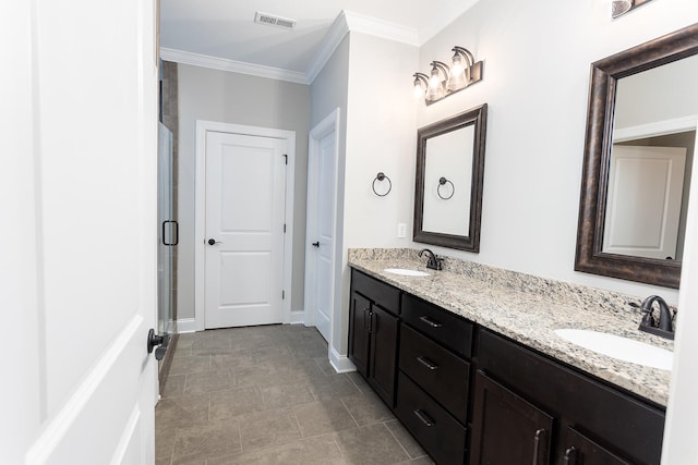 bathroom featuring vanity, a shower with shower door, and ornamental molding