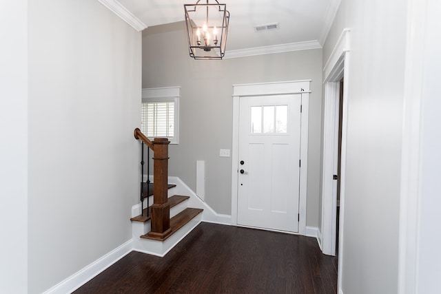 foyer entrance featuring a chandelier, dark hardwood / wood-style flooring, and ornamental molding