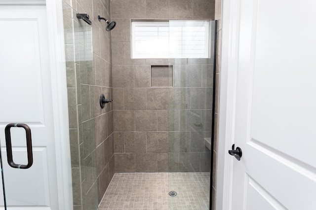 bathroom featuring a shower with door