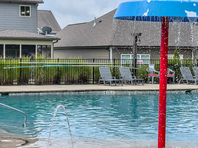 view of swimming pool featuring a sunroom