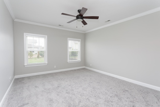 carpeted empty room with ceiling fan and ornamental molding