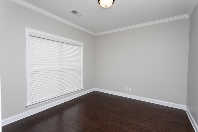 empty room featuring dark hardwood / wood-style flooring and ornamental molding