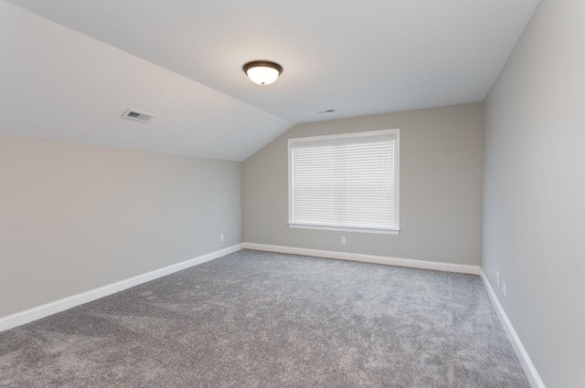 additional living space with carpet flooring and vaulted ceiling