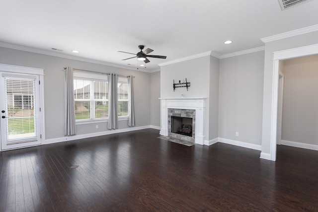 unfurnished living room featuring dark hardwood / wood-style floors, ceiling fan, and ornamental molding