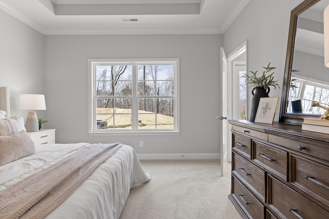 bedroom featuring visible vents, baseboards, a raised ceiling, light carpet, and ornamental molding