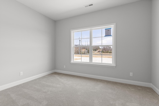 carpeted empty room with baseboards and visible vents
