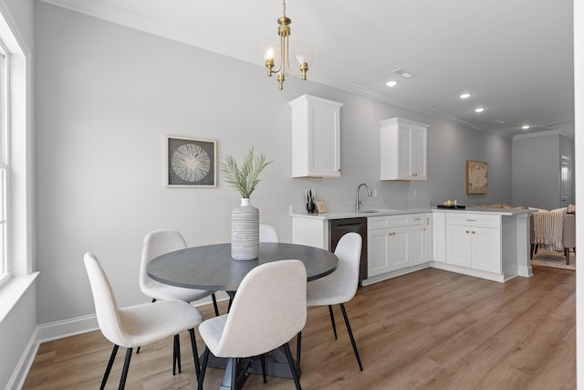 dining area with ornamental molding, light wood-type flooring, recessed lighting, an inviting chandelier, and baseboards
