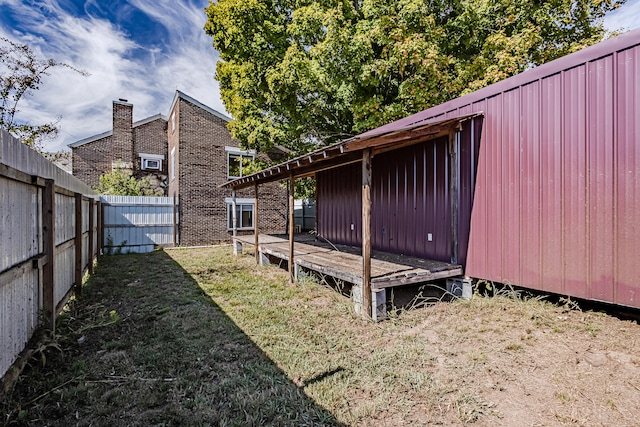 view of yard with an outdoor structure and a deck