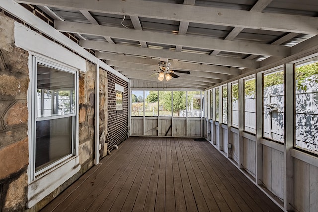 unfurnished sunroom featuring ceiling fan