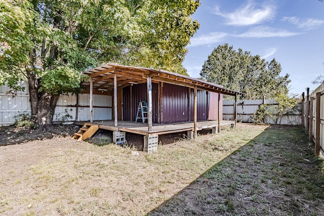 rear view of property with a lawn and an outbuilding