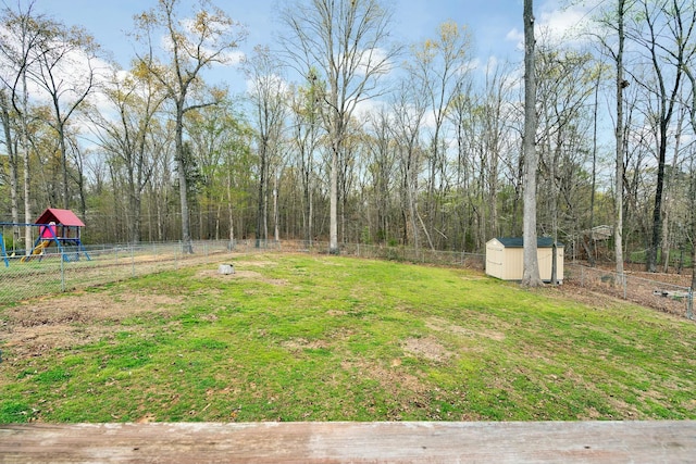 view of yard featuring fence, a shed, and an outdoor structure