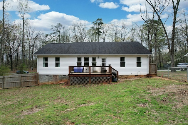rear view of property featuring crawl space, a wooden deck, fence, and a lawn