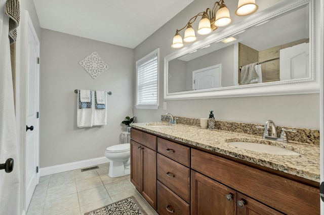 bathroom with baseboards, visible vents, a sink, and tile patterned flooring