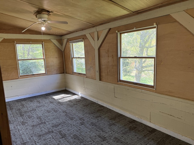 bonus room featuring a ceiling fan, carpet floors, wooden walls, and wooden ceiling