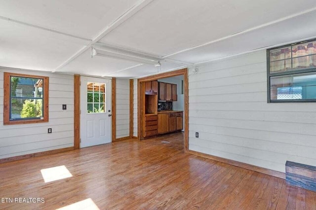 interior space with wood-type flooring and wood walls