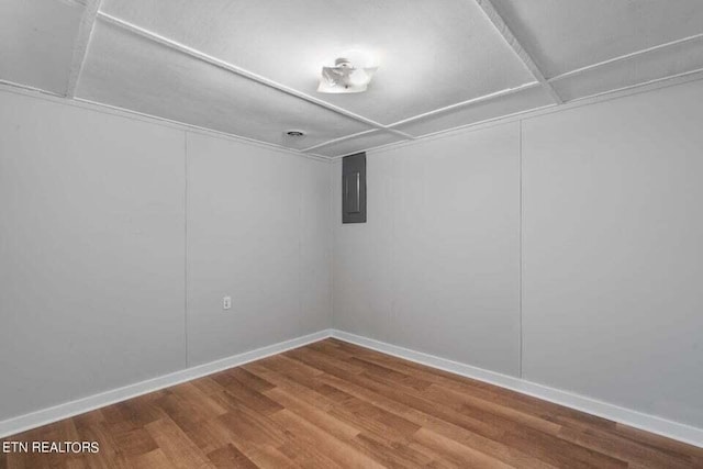 unfurnished room with hardwood / wood-style floors and electric panel