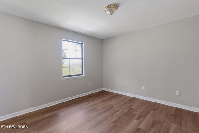 unfurnished room featuring hardwood / wood-style floors