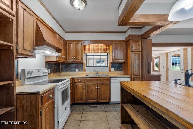 kitchen featuring wood counters, sink, white appliances, and plenty of natural light