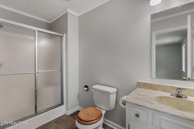 bathroom with walk in shower, ornamental molding, vanity, and toilet