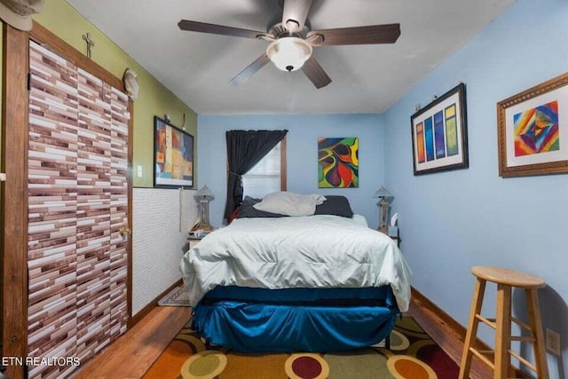 bedroom featuring ceiling fan and hardwood / wood-style floors