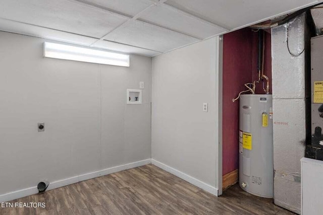 interior space featuring washer hookup, hookup for an electric dryer, hardwood / wood-style floors, and water heater